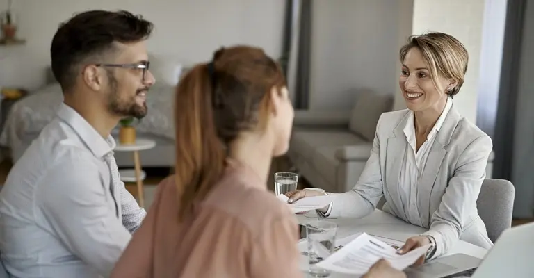 dos personas con una agente de bienes raíces